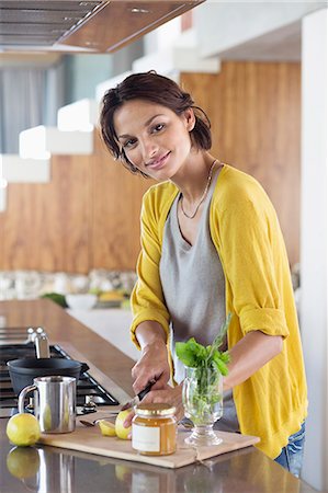 single lemon - Woman preparing herbal tea in the kitchen Stock Photo - Premium Royalty-Free, Code: 6108-06907103