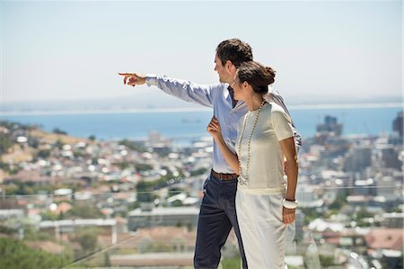 simsearch:6108-06907503,k - Couple looking at city view from a terrace Stock Photo - Premium Royalty-Free, Code: 6108-06907118
