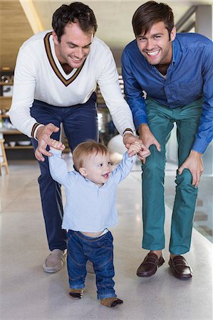 Parents helping their son to walk Stock Photo - Premium Royalty-Free, Code: 6108-06907347