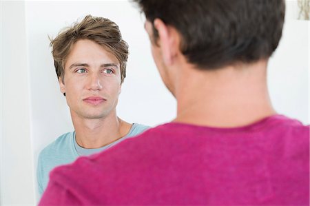 Two male friends talking to each other Stock Photo - Premium Royalty-Free, Code: 6108-06907315