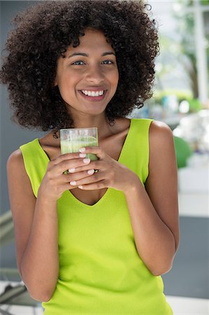 simsearch:6108-07969525,k - Portrait of a woman holding a glass of kiwi juice Stock Photo - Premium Royalty-Free, Code: 6108-06907446