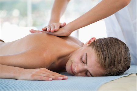 Woman receiving back massage from a massage therapist Stock Photo - Premium Royalty-Free, Code: 6108-06907497