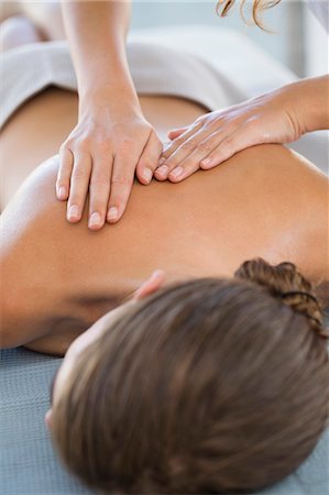 Woman receiving back massage from a massage therapist Stock Photo - Premium Royalty-Free, Code: 6108-06907496