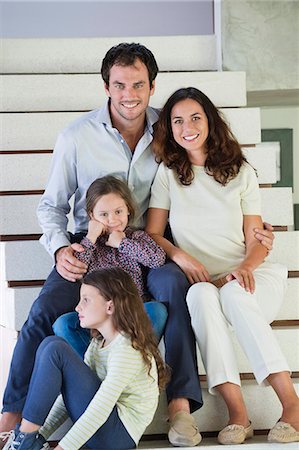 simsearch:6108-06907623,k - Couple with their children sitting on steps Photographie de stock - Premium Libres de Droits, Code: 6108-06907647