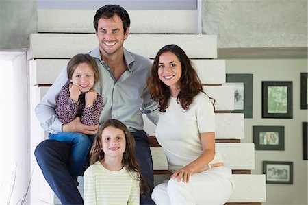 simsearch:6108-06907621,k - Family sitting on steps and smiling Stock Photo - Premium Royalty-Free, Code: 6108-06907652