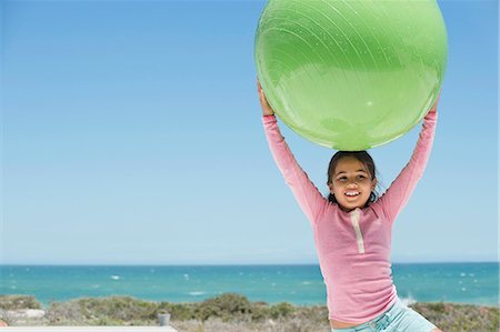simsearch:6108-06907957,k - Girl holding a fitness ball on the beach Stock Photo - Premium Royalty-Free, Code: 6108-06907892