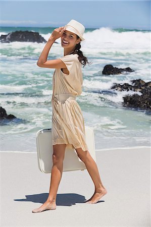 simsearch:6108-06907213,k - Beautiful woman carrying a suitcase on the beach Stock Photo - Premium Royalty-Free, Code: 6108-06907944