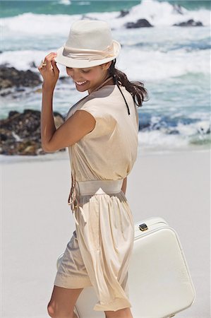simsearch:6108-06907213,k - Beautiful woman carrying a suitcase on the beach Stock Photo - Premium Royalty-Free, Code: 6108-06907948