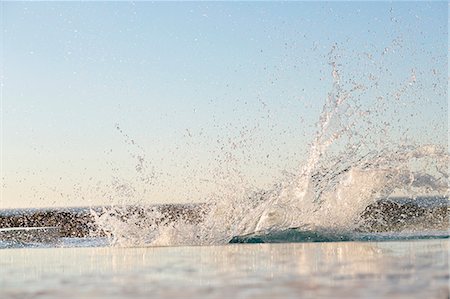 Water being splashed into a swimming pool Stock Photo - Premium Royalty-Free, Code: 6108-06907910