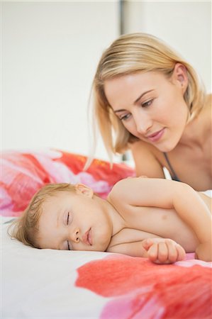 simsearch:6108-06907900,k - Woman looking at her baby sleeping on the bed Stock Photo - Premium Royalty-Free, Code: 6108-06908153