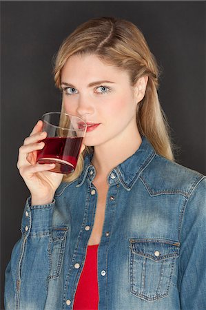 simsearch:6108-07969525,k - Portrait of a beautiful woman drinking juice Stock Photo - Premium Royalty-Free, Code: 6108-07969588