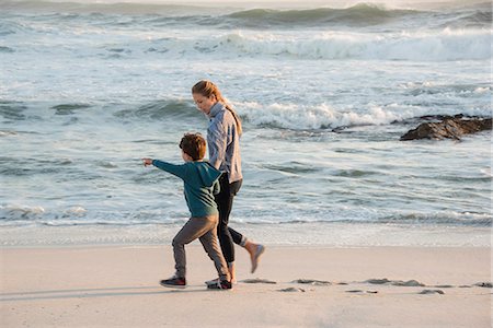 simsearch:6109-06003758,k - Happy mother and son walking on the beach Stock Photo - Premium Royalty-Free, Code: 6108-08662295