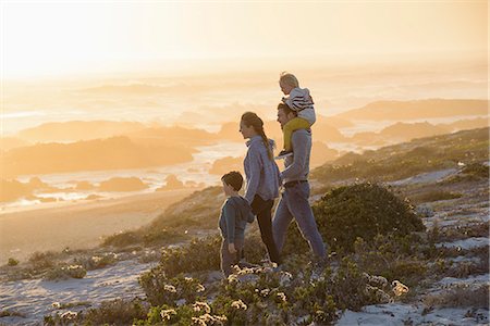 simsearch:649-07803505,k - Happy young family walking on the beach at sunset Stock Photo - Premium Royalty-Free, Code: 6108-08662299