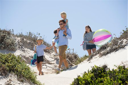 romantic boy and girl - Couple walking on the beach with their children Stock Photo - Premium Royalty-Free, Code: 6108-08662378