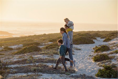 simsearch:649-07803505,k - Happy young family walking on the beach at sunset Stock Photo - Premium Royalty-Free, Code: 6108-08662301