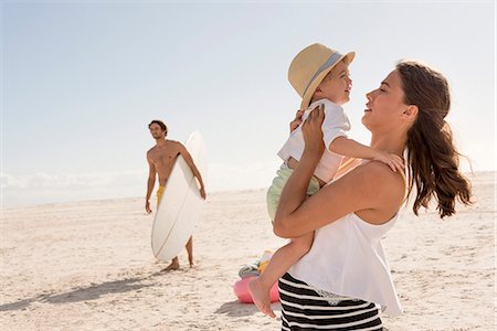 surf board - Happy young family enjoying on beach Stock Photo - Premium Royalty-Free, Code: 6108-08662673