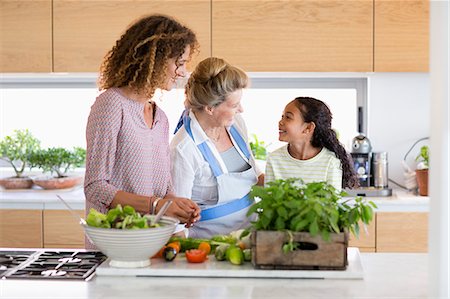 Senior woman with daughter and granddaughter in kitchen Stock Photo - Premium Royalty-Free, Code: 6108-08662793