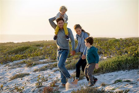 simsearch:649-07803505,k - Happy young family walking on the beach at sunset Stock Photo - Premium Royalty-Free, Code: 6108-08663181