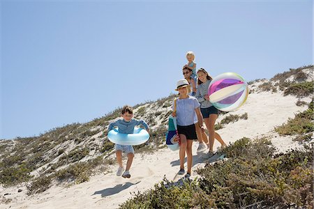 father son beach - Couple walking on the beach with their children Stock Photo - Premium Royalty-Free, Code: 6108-08663196