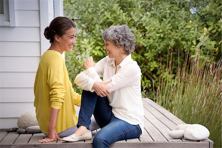photo of person sitting on porch - Happy mother talking with her adult daughter on porch Stock Photo - Premium Royalty-Free, Code: 6108-08663277