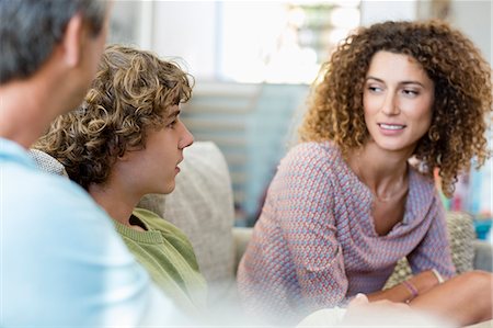 family father son - Happy family talking in a living room at home Stock Photo - Premium Royalty-Free, Code: 6108-08663222