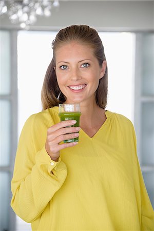 simsearch:6108-07969525,k - Close-up of a beautiful woman holding a glass of vegetable juice Stock Photo - Premium Royalty-Free, Code: 6108-08663302