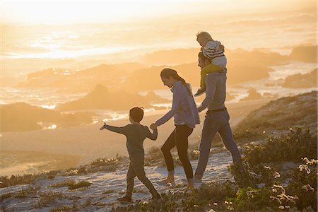 simsearch:649-07803505,k - Happy young family walking on the beach at sunset Stock Photo - Premium Royalty-Free, Code: 6108-08663423