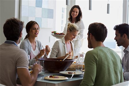simsearch:6108-06906790,k - Group of friends having lunch at dining table Stock Photo - Premium Royalty-Free, Code: 6108-08663426