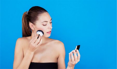 simsearch:6108-08637407,k - Portrait of a woman using make-up brush on face Stock Photo - Premium Royalty-Free, Code: 6108-08637245