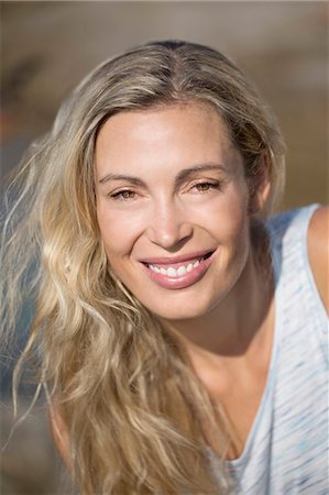 Close-up of smiling blond woman Stock Photo - Premium Royalty-Free, Code: 6108-08637290