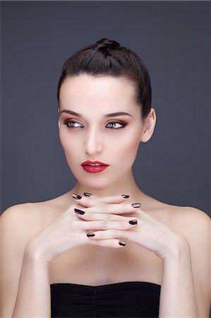 simsearch:6108-08637407,k - Portrait of a young woman hands under chin, looking to the side Stock Photo - Premium Royalty-Free, Code: 6108-08637325