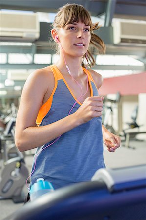 Beautiful woman exercising in a fitness club Stock Photo - Premium Royalty-Free, Code: 6108-08725182