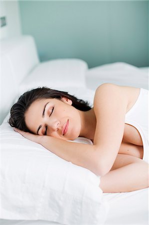 simsearch:6109-06194941,k - Portrait of a pretty woman sleeping in bed Stock Photo - Premium Royalty-Free, Code: 6108-08909197