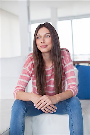 simsearch:614-01179436,k - Pretty brunette woman at the sofa daydreaming Stock Photo - Premium Royalty-Free, Code: 6108-08909761