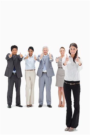 simsearch:6109-06002816,k - Smiling business team with their thumbs-up with a woman in foreground against white background Stock Photo - Premium Royalty-Free, Code: 6109-06002689