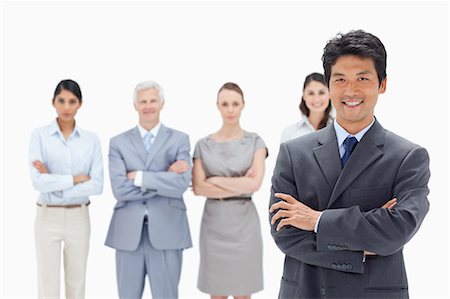 simsearch:6109-06002816,k - Close-up of a business team crossing their arms with a smiling Asian man in foreground against white background Stock Photo - Premium Royalty-Free, Code: 6109-06002692