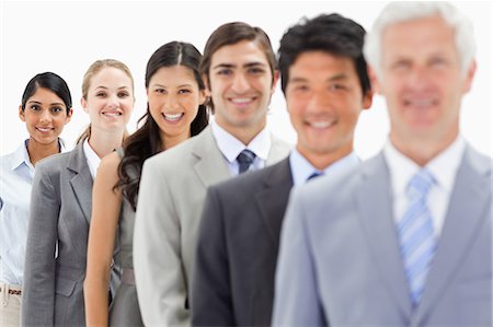 simsearch:6109-06002816,k - Close-up of smiling business people in a single line with focus on the last person against white background Stock Photo - Premium Royalty-Free, Code: 6109-06002751