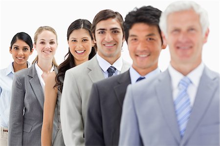 simsearch:6109-06002816,k - Close-up of smiling business people in a single line with focus on the fifth person against white background Stock Photo - Premium Royalty-Free, Code: 6109-06002752