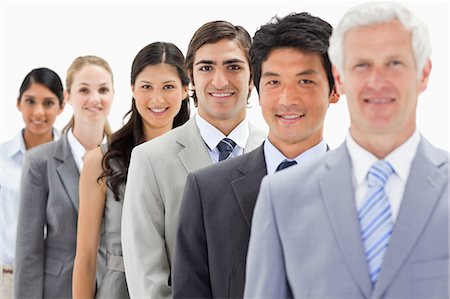 simsearch:6109-06002816,k - Close-up of smiling business people in a single line with focus on the third person against white background Stock Photo - Premium Royalty-Free, Code: 6109-06002754