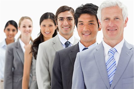 simsearch:6109-06002816,k - Close-up of smiling business people in a single line with focus on the second against white background Stock Photo - Premium Royalty-Free, Code: 6109-06002755