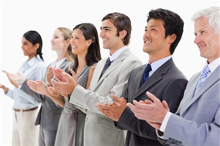 simsearch:6109-06002816,k - Smiling multicultural business people applauding against white background Stock Photo - Premium Royalty-Free, Code: 6109-06002763