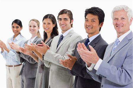 Close-up of multicultural business people posing and applauding against white background Foto de stock - Sin royalties Premium, Código: 6109-06002765