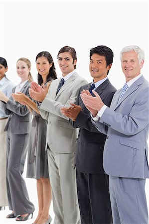 simsearch:6109-06002816,k - Multicultural business people applauding and posing against white background Stock Photo - Premium Royalty-Free, Code: 6109-06002766