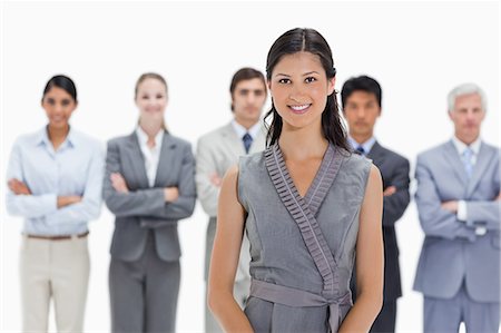 simsearch:6109-06002816,k - Woman with business team behind her against white background Stock Photo - Premium Royalty-Free, Code: 6109-06002776