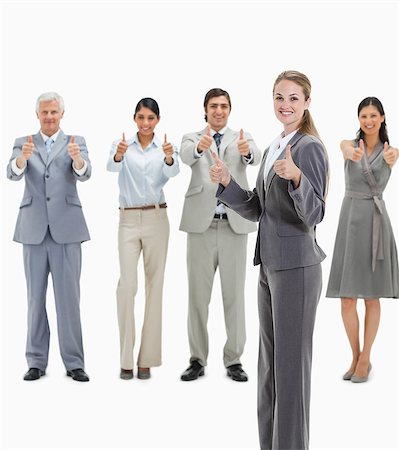 standing - Blonde woman smiling with business people approving behind her against white background Stock Photo - Premium Royalty-Free, Code: 6109-06002799