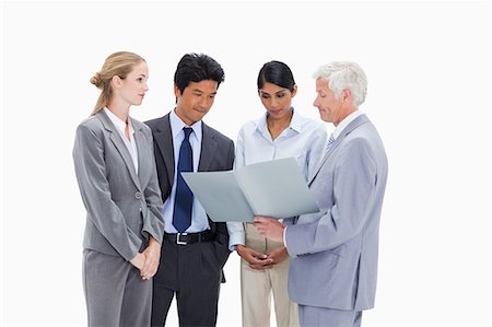simsearch:6109-06002816,k - Embarrassed boss showing a file to his employees against white background Stock Photo - Premium Royalty-Free, Code: 6109-06002853