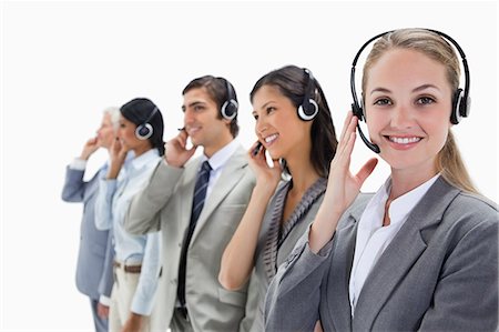 simsearch:6109-06002816,k - Smiling professionals listening with headsets against white background Stock Photo - Premium Royalty-Free, Code: 6109-06002811