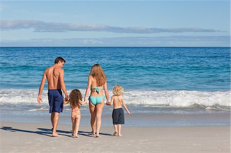 simsearch:6109-06003758,k - Young family spending their time on the beach Stock Photo - Premium Royalty-Free, Code: 6109-06003613