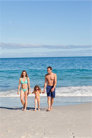 simsearch:6109-06003758,k - Young family walking on the beach Stock Photo - Premium Royalty-Free, Code: 6109-06003611