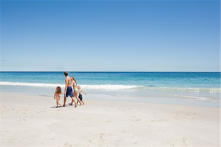 simsearch:6109-06003758,k - Young family walking along the beach Stock Photo - Premium Royalty-Free, Code: 6109-06003759